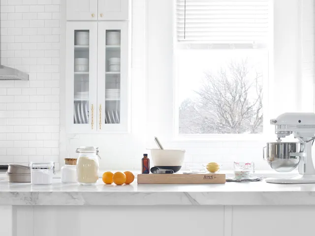 Straight-on shot of Kitchen studio with large marble island 