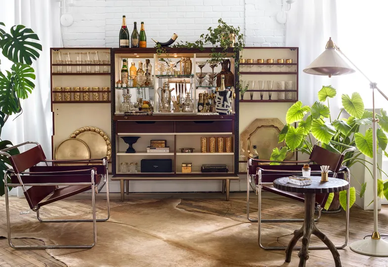 Bar cabinet in Loft studio flanked by modern leather and chrome chairs