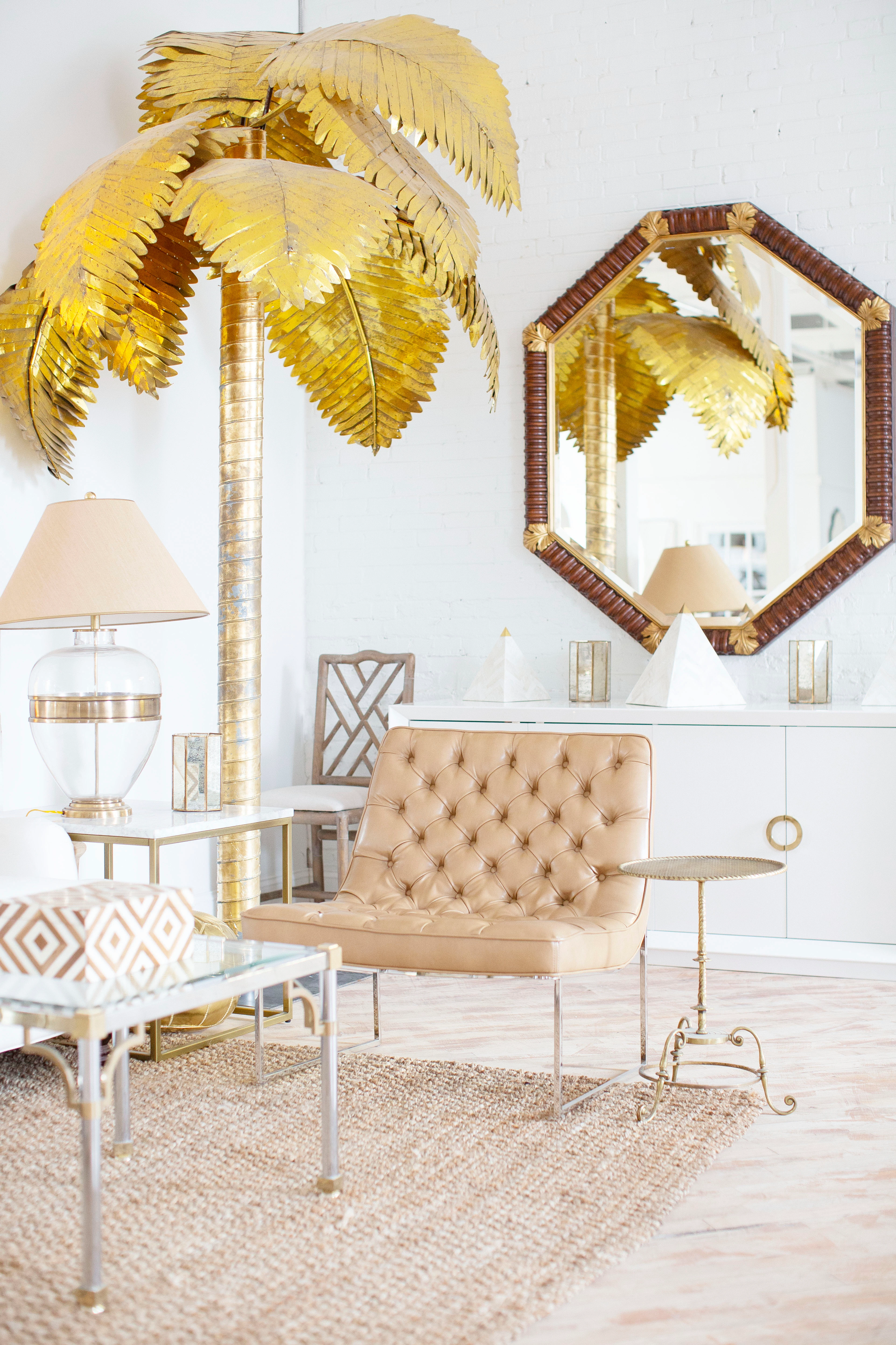 A seating group in the shade of a hand-gilded palm tree