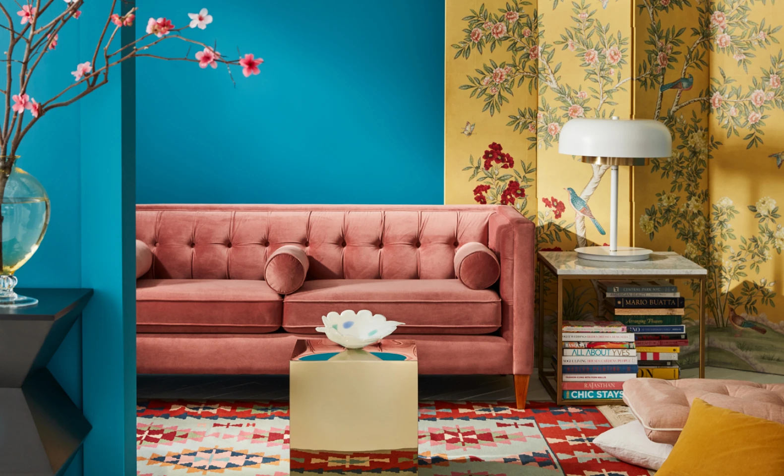 Living room set with pink sofa and yellow floral screen