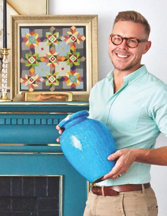 Portrait of Eddie Ross holding a blue vase