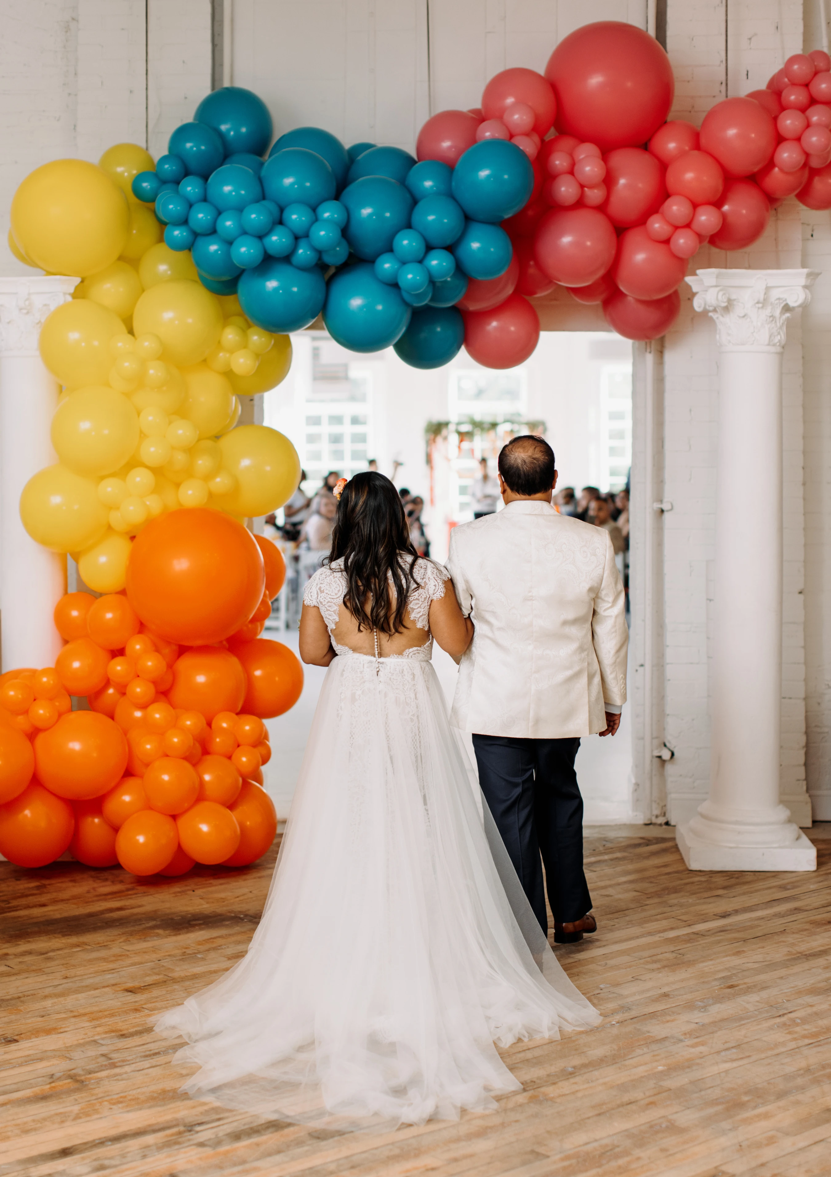 Bride and groom posing on a window sill after their ceremony in the Gallery