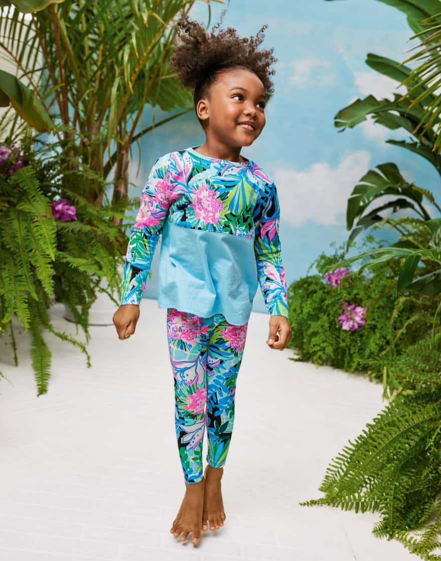 Female child in courtyard set with tropical plants