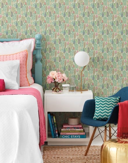 Bedroom set with wallpaper in small green print accented with pink bedding