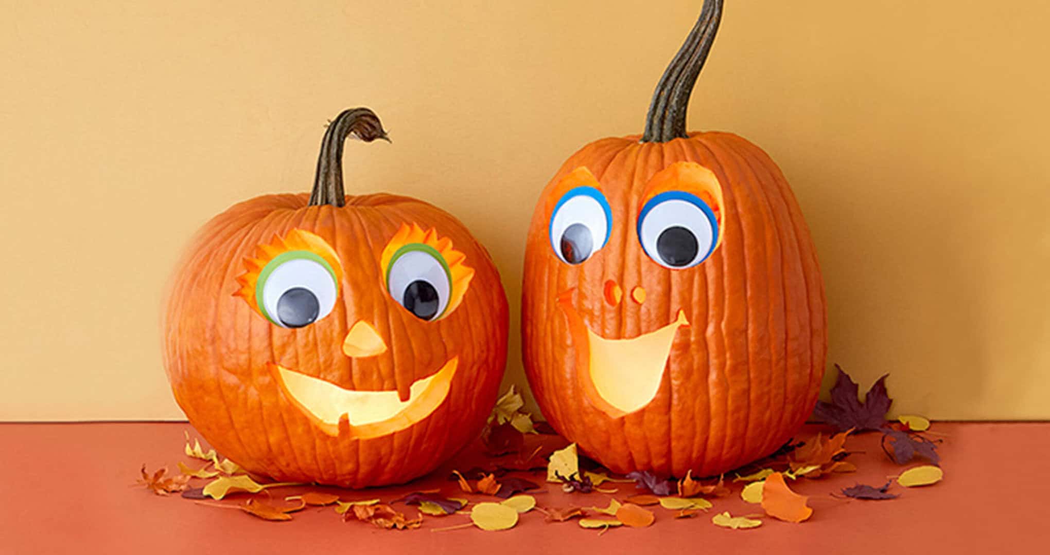 Two orange pumpkins with googly eyes