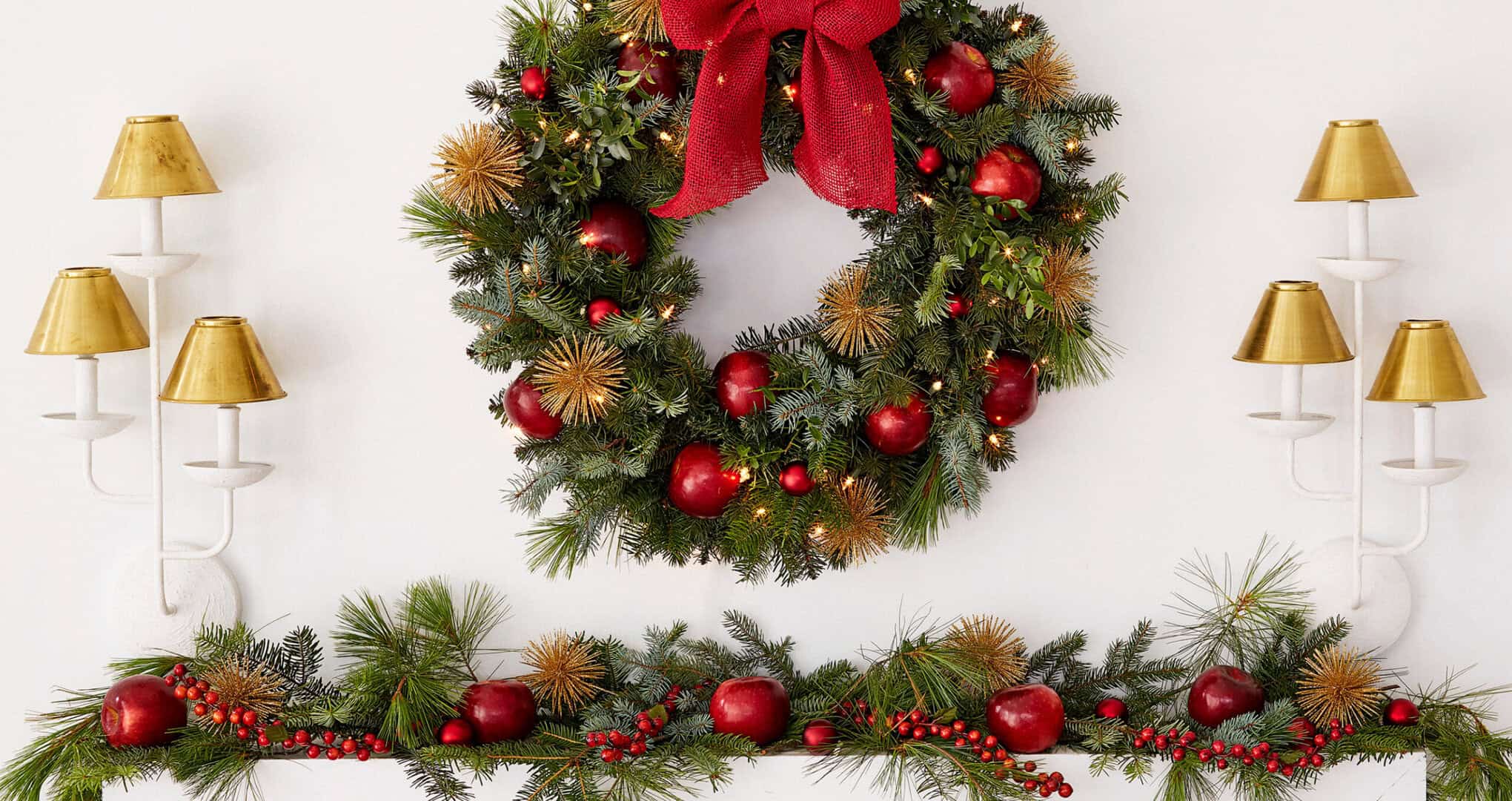 A wreath and garland decorated with applied over a fireplace