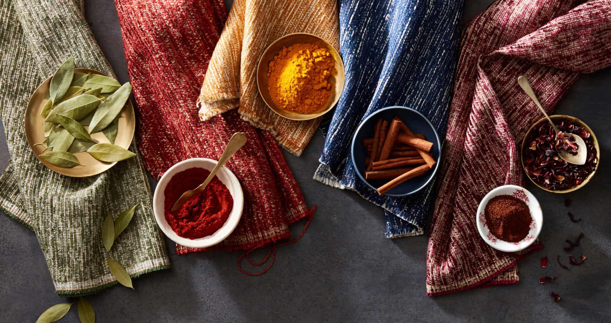 Overhead of fabric swatches propped with spices