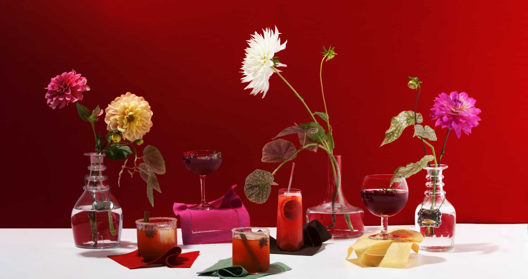 Vibrant red cocktail party vignette with vases and glasses