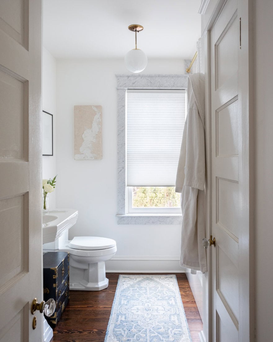 Bathroom with motorized window shade