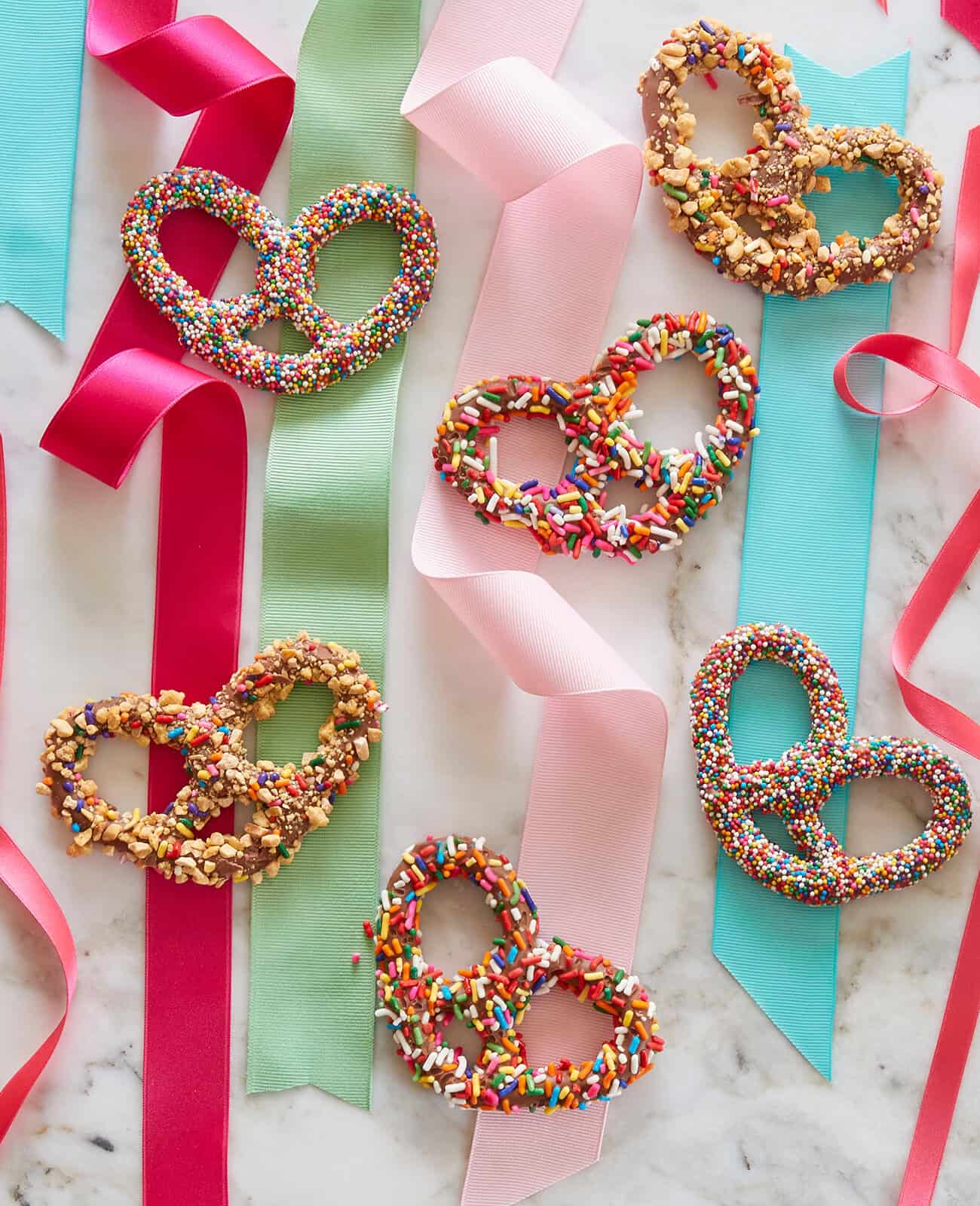 Overhead of chocolate-covered pretzels with colorful ribbon