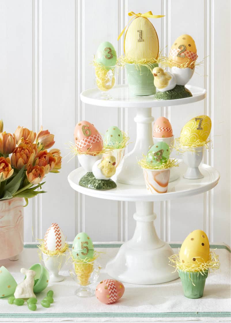 Easter advent calendar with painted eggs on stacked cake pedestals