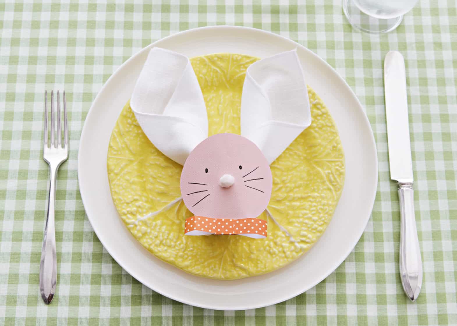 Place setting with napkin folded to look like bunny ears