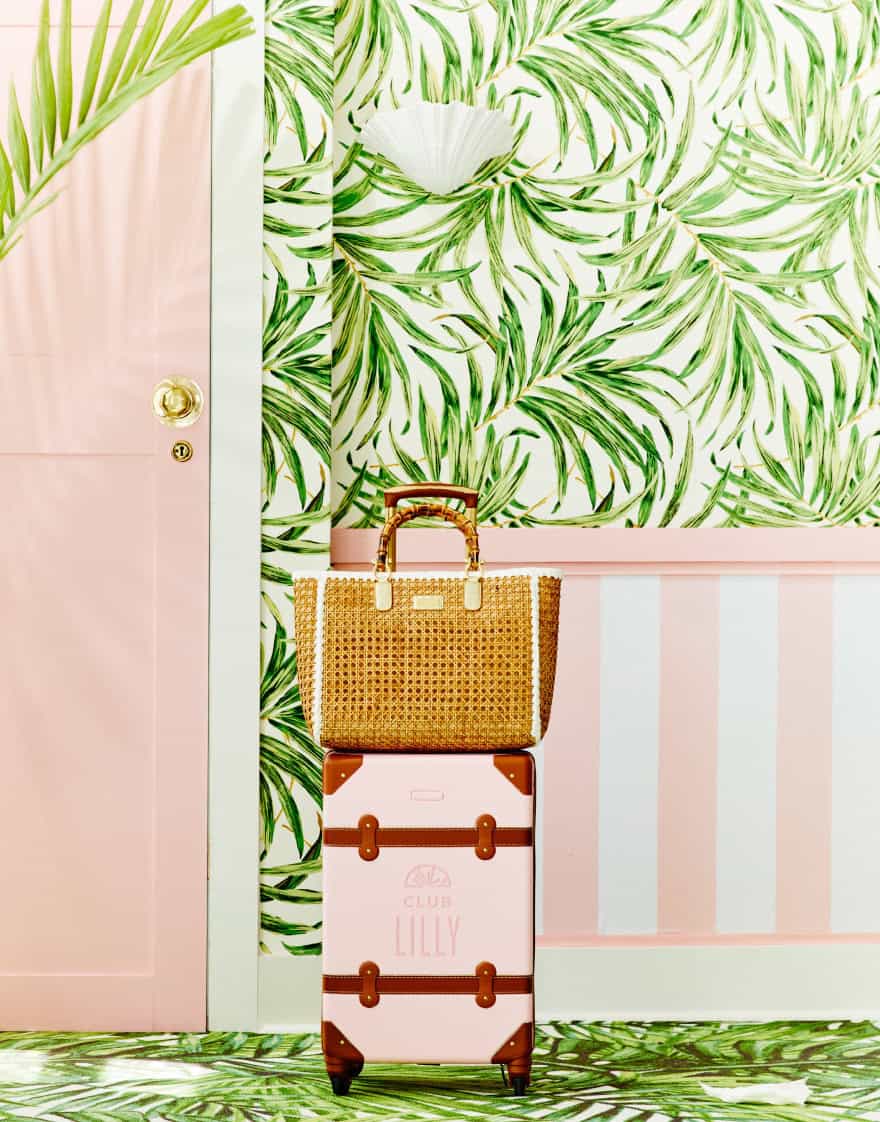 Palm Beach-inspired set of a hotel hallway with pink luggage