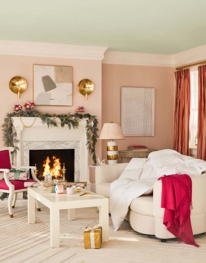 Living room set decorated for the holidays with crackling fire