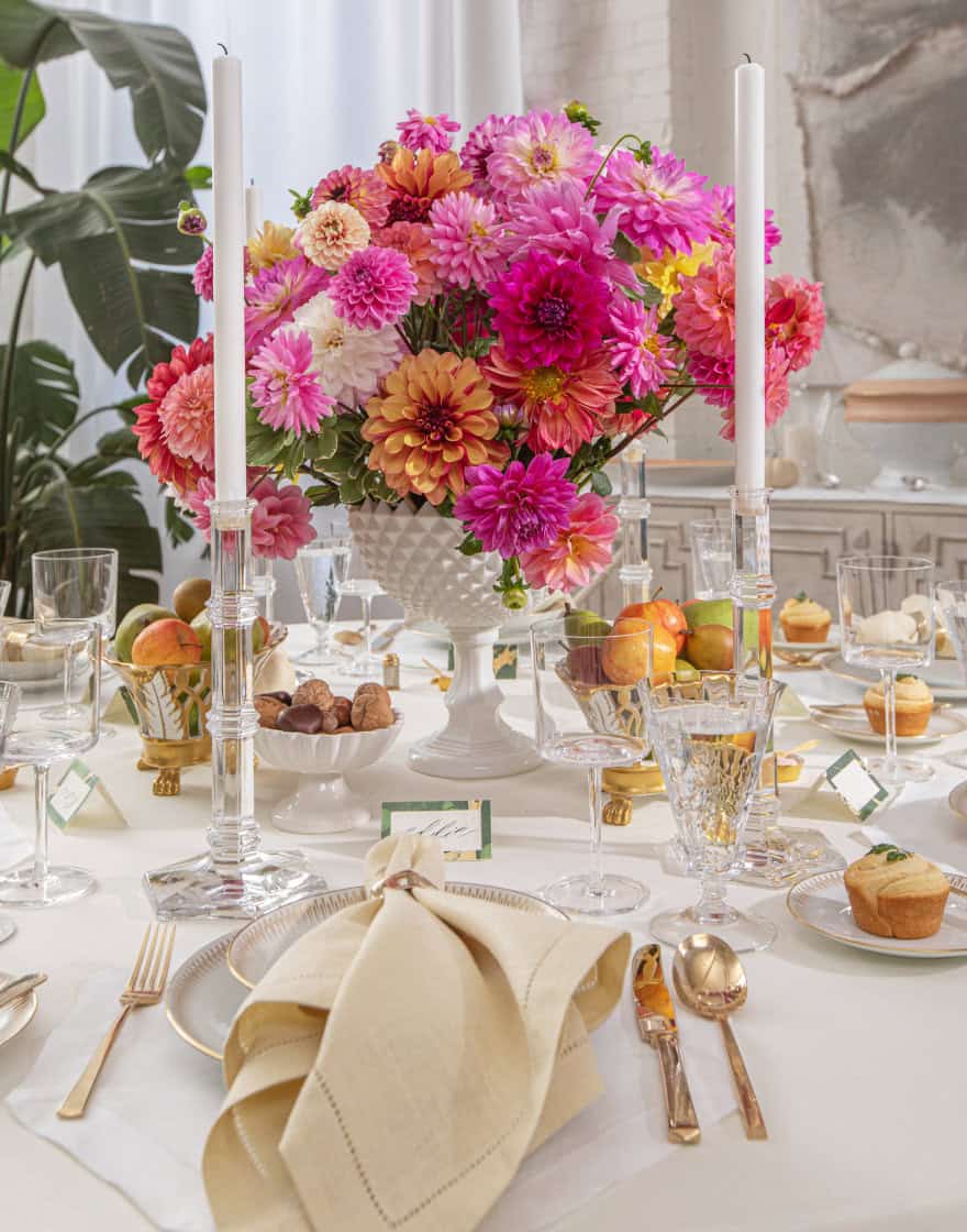 Table setting in our Loft Studio with fine linens and centerpiece of vibrant dahlias