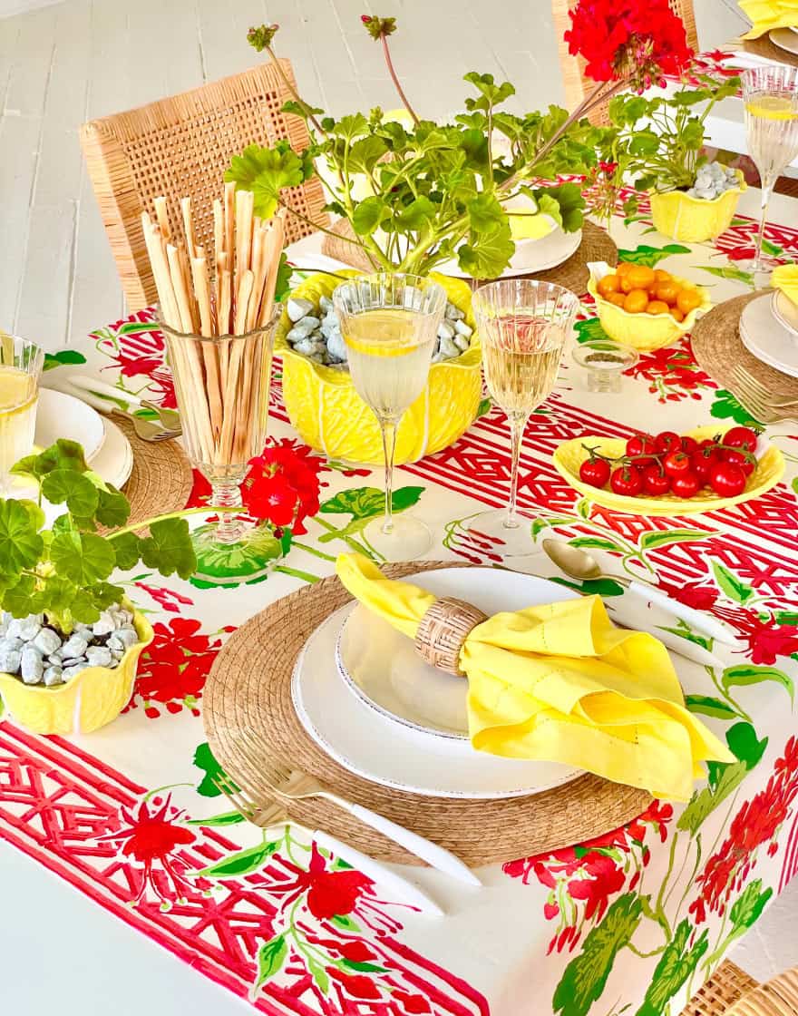 Detail of place setting and breadsticks in a celery vase as table decor