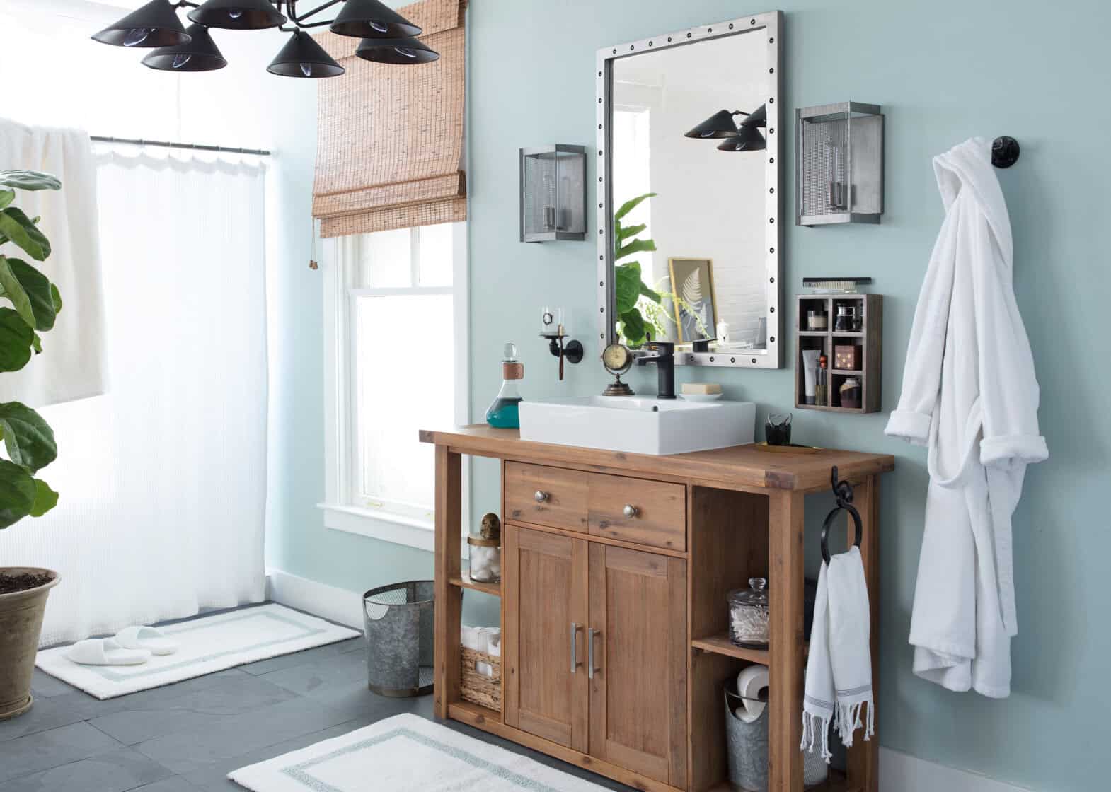 Bathroom set with blue walls and wood vanity