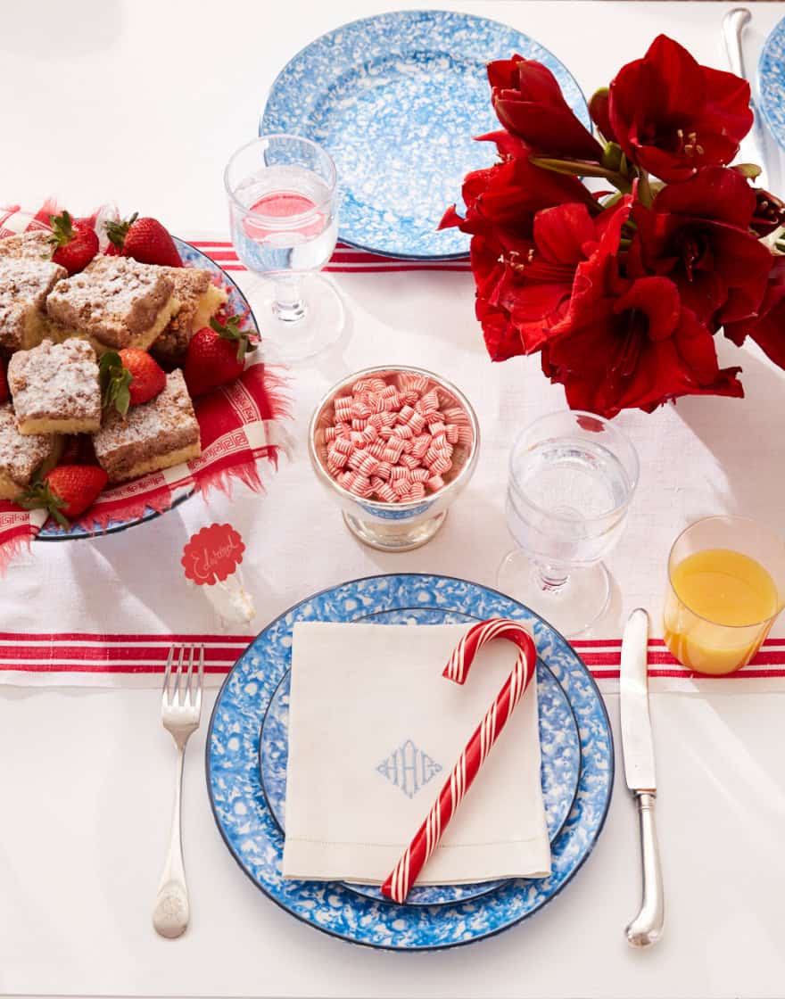 Overhead of holiday table set for Christmas breakfast in blue and red