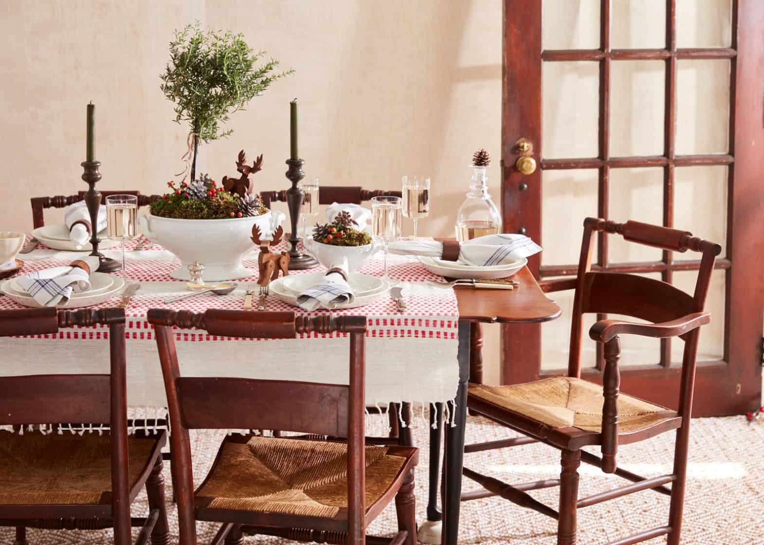 Dining room set of red and white table setting with vintage wood chairs