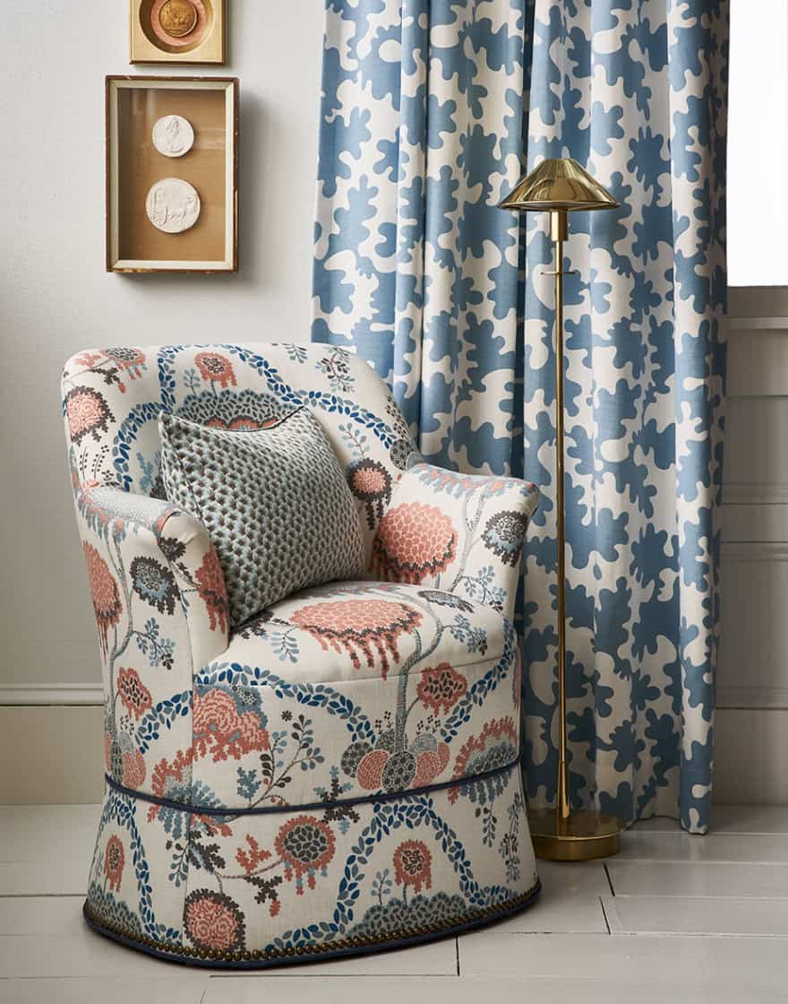 Vignette with upholstered armchair and curtains