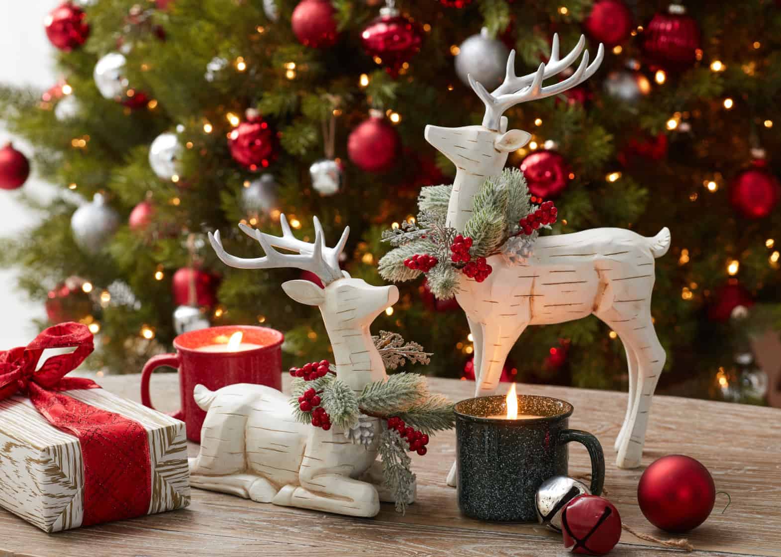 Wooden reindeer figures embellished with greenery and ribbon