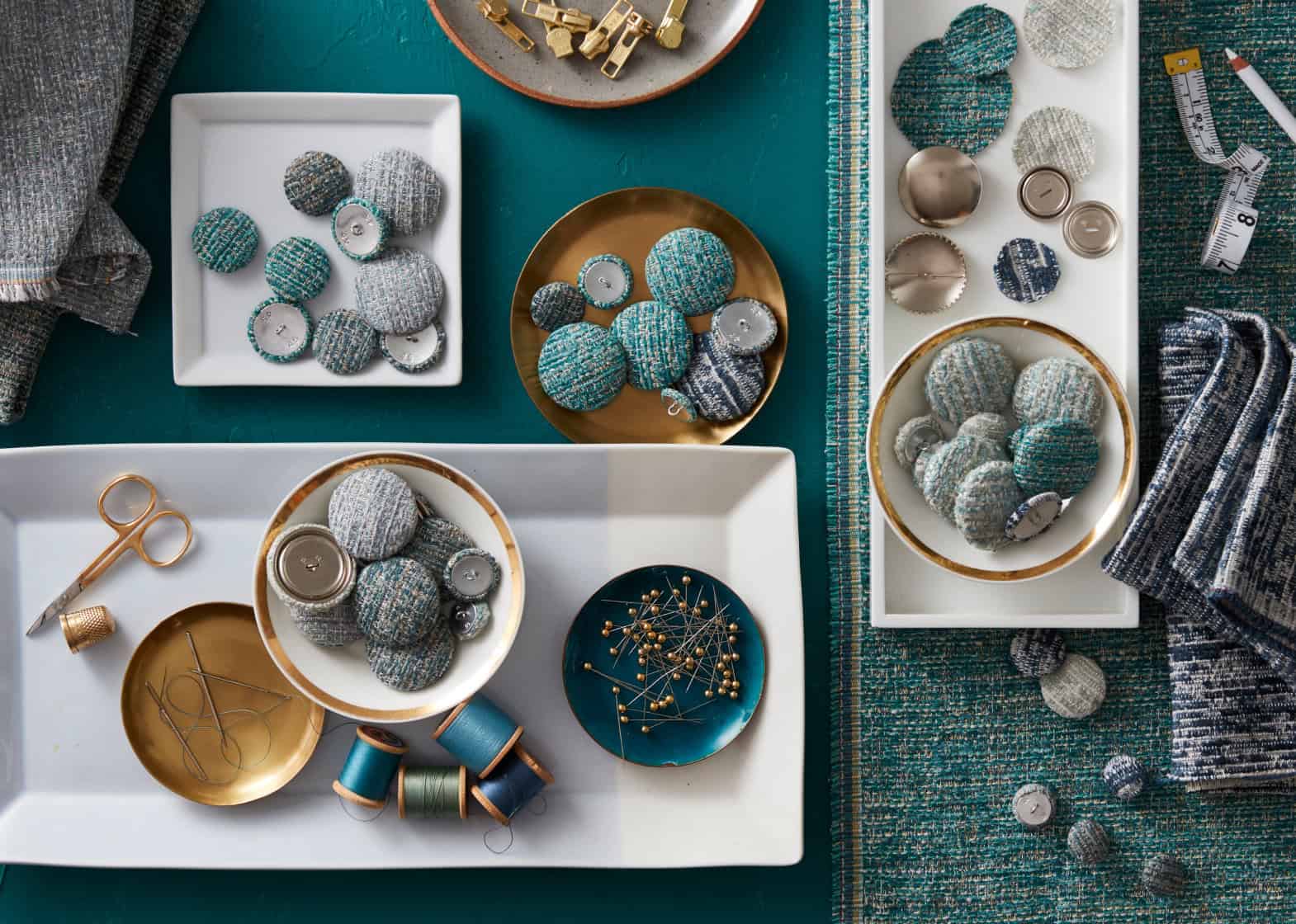 Overhead of fabric-covered buttons in white trays