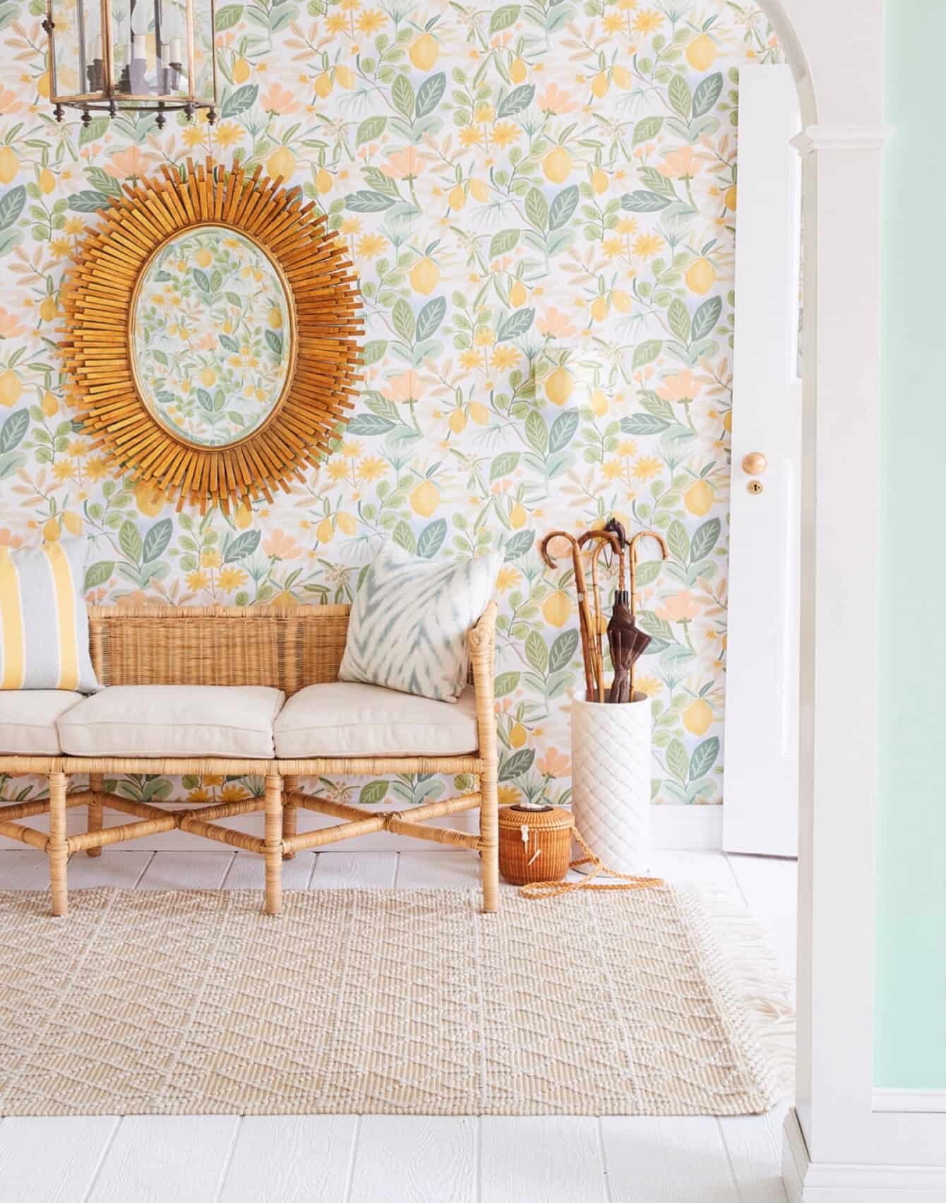 Foyer set with wallpaper and rattan bench and sunburst mirror