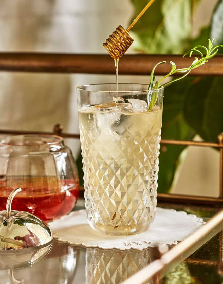 Cocktail in vintage glassware on a bar cart