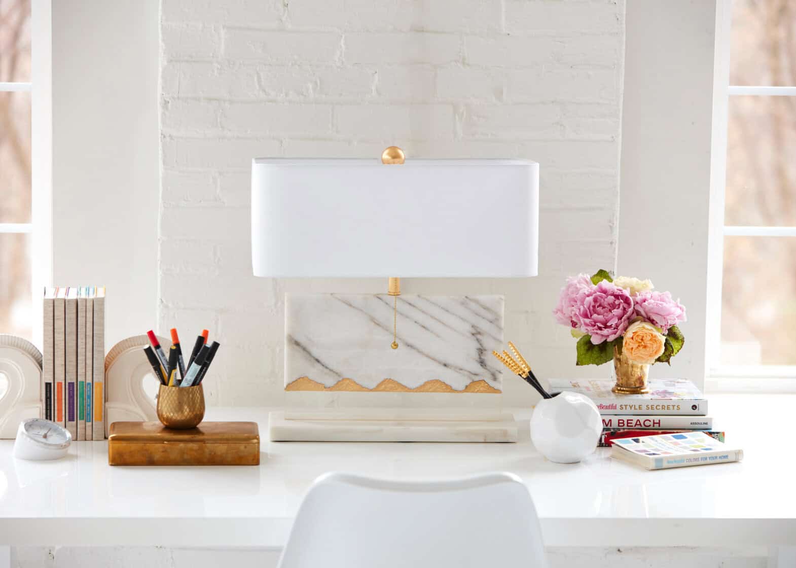 Table lamp vignette with studio office look against white brick