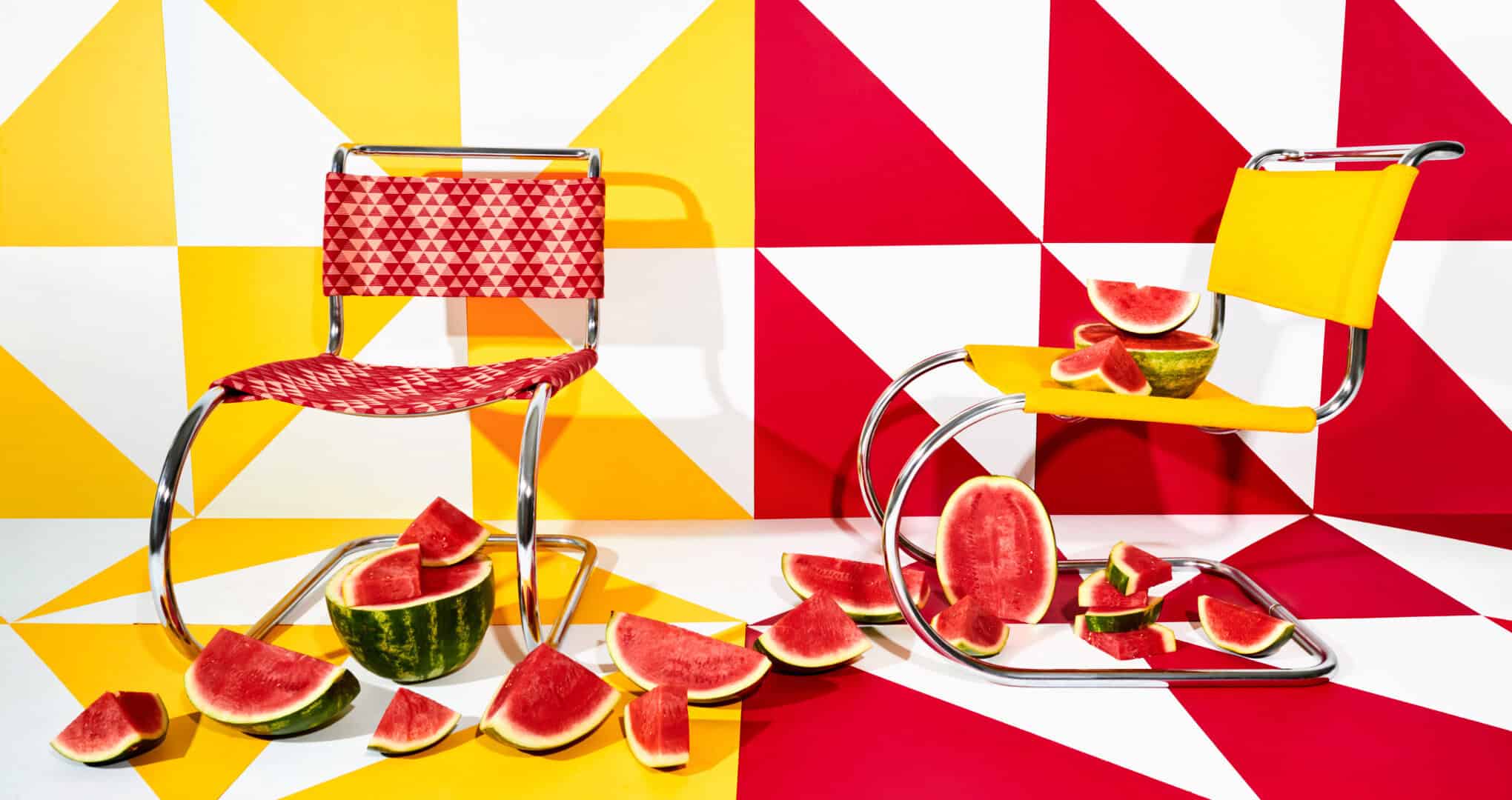 Modern chrome chairs upholstered in red and yellow geometric prints