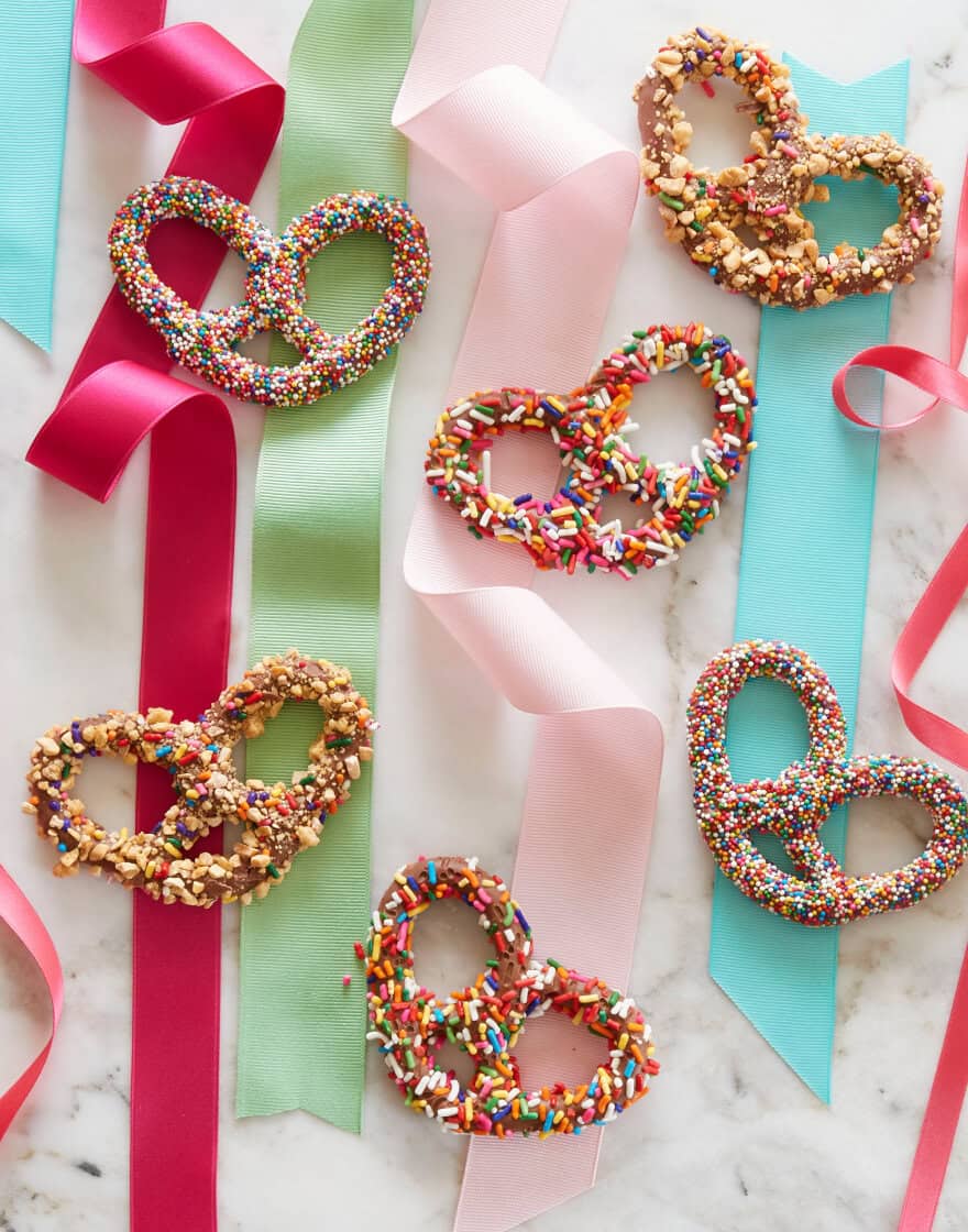 Overhead of chocolate-covered pretzels with colorful ribbon